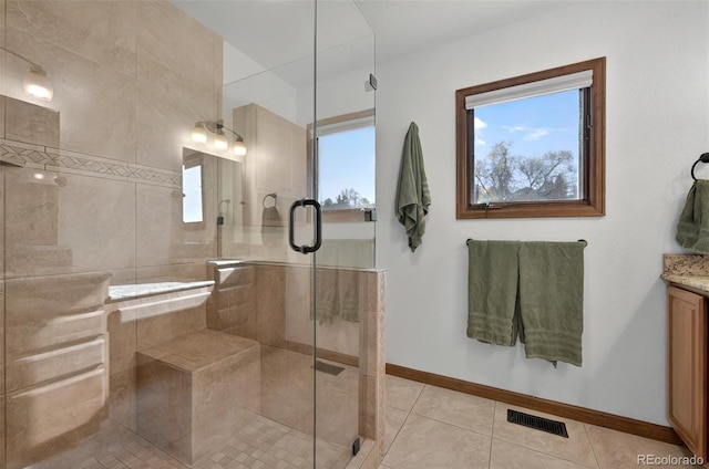 723 Orion Dr, Colorado Springs, CO 80906 - bathroom with vanity, a stall shower, healthy amount of natural light, and tile patterned floors