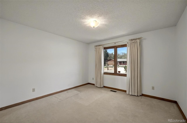 723 Orion Dr, Colorado Springs, CO 80906 - spare room with light colored carpet, baseboards, and a textured ceiling