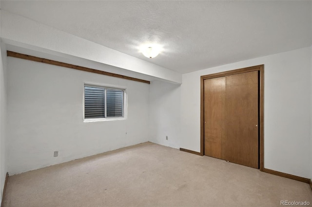 723 Orion Dr, Colorado Springs, CO 80906 - unfurnished bedroom featuring light colored carpet, a closet, and a textured ceiling