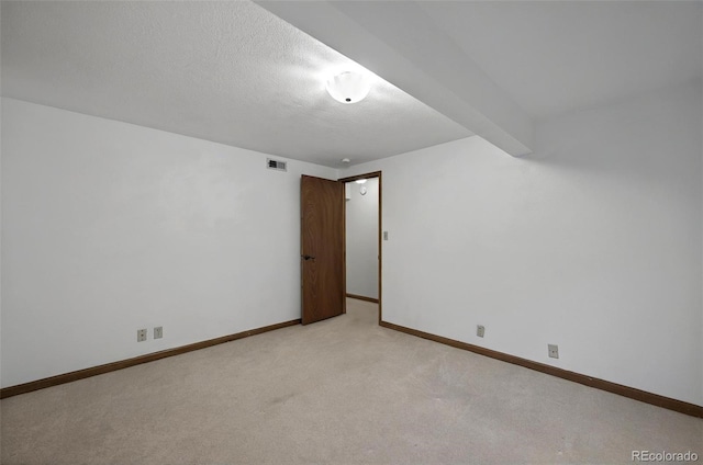 723 Orion Dr, Colorado Springs, CO 80906 - spare room with light carpet, baseboards, and a textured ceiling