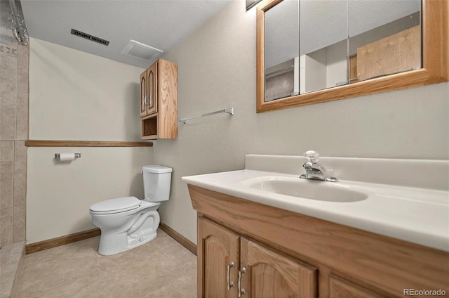 723 Orion Dr, Colorado Springs, CO 80906 - full bath with vanity, toilet, baseboards, and tile patterned flooring