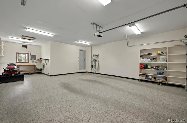 723 Orion Dr, Colorado Springs, CO 80906 - garage with a garage door opener and baseboards