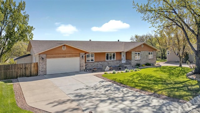 723 Orion Dr, Colorado Springs, CO 80906 - view of front facade featuring driveway, a garage, brick siding, and stone siding