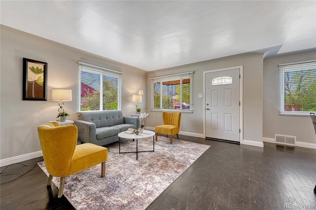 living area featuring dark wood finished floors and baseboards
