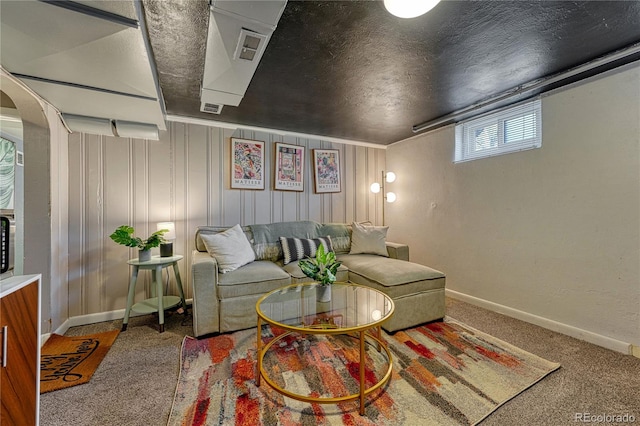 carpeted living room featuring baseboards