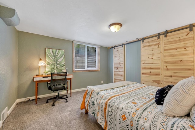 carpeted bedroom with baseboards and a textured wall