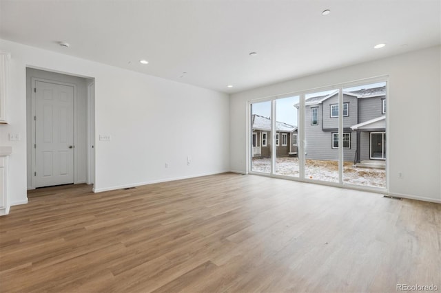 unfurnished living room with light wood-type flooring