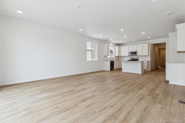 unfurnished living room featuring light hardwood / wood-style floors