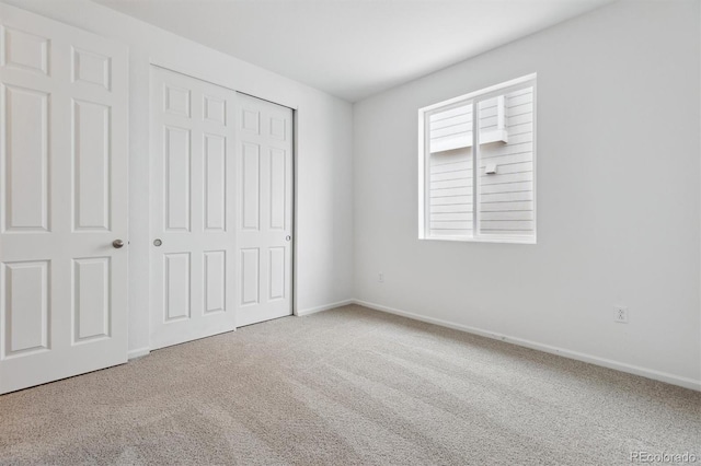 unfurnished bedroom featuring a closet and carpet