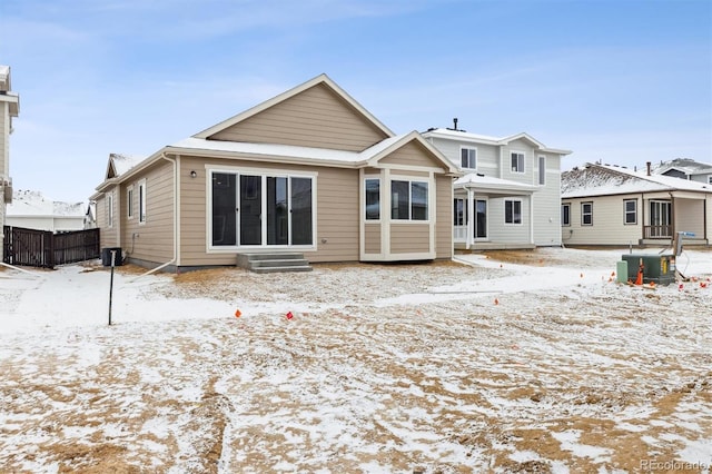 snow covered property featuring central AC unit