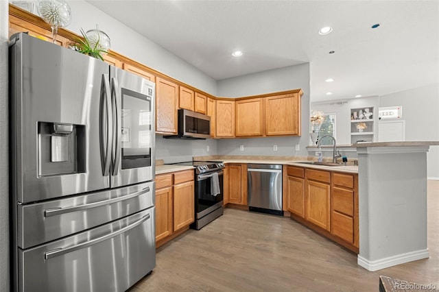 3026 S Waco Ct, Aurora, CO 80013 - kitchen featuring stainless steel appliances, a peninsula, light wood-style flooring, light countertops, and recessed lighting