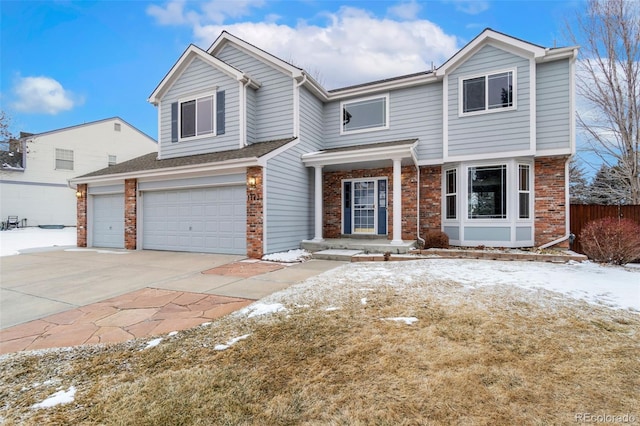 view of front of house with a garage, brick siding, and driveway