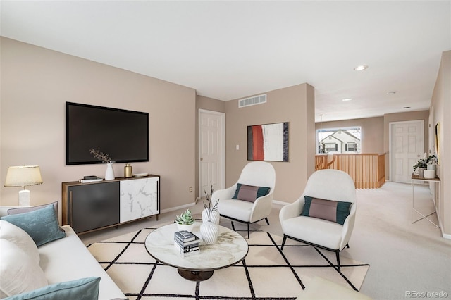 living room featuring baseboards, recessed lighting, visible vents, and light colored carpet