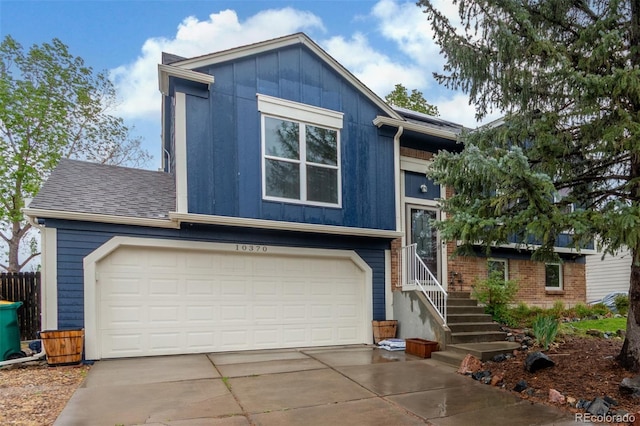 10370 Routt St, Westminster, CO 80021 - split foyer home with driveway, board and batten siding, an attached garage, and a shingled roof
