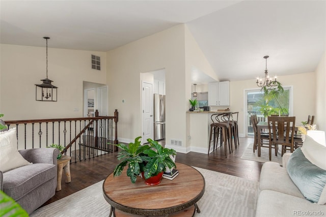 10370 Routt St, Westminster, CO 80021 - living room featuring a chandelier, dark wood-type flooring, baseboards, and high vaulted ceiling