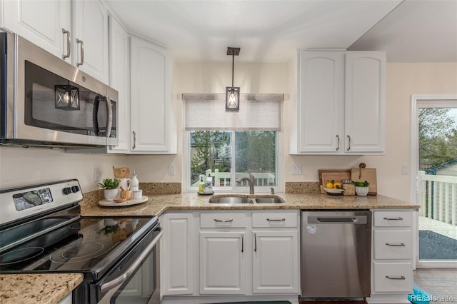 10370 Routt St, Westminster, CO 80021 - kitchen featuring appliances with stainless steel finishes, a sink, white cabinetry, and light stone counters