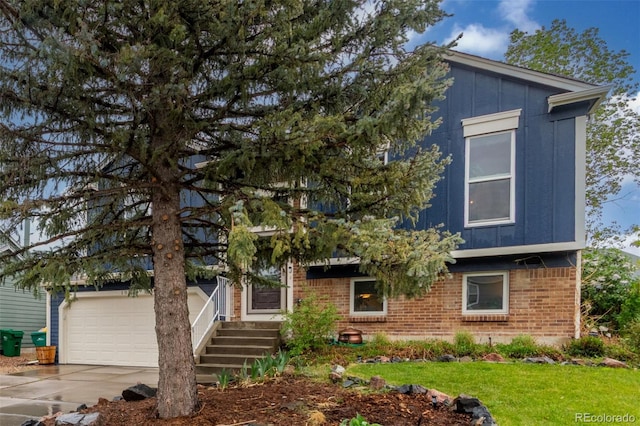 10370 Routt St, Westminster, CO 80021 - view of front facade featuring brick siding, driveway, and a front lawn