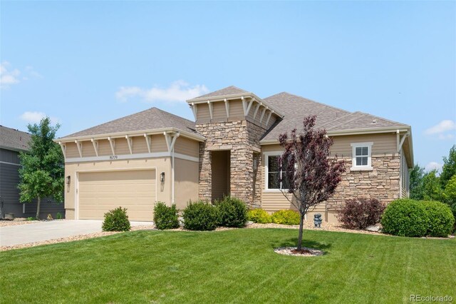 15779 W 83rd Pl, Arvada, CO 80007 - view of front of home with stone siding, driveway, a front yard, and an attached garage