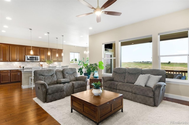 15779 W 83rd Pl, Arvada, CO 80007 - living area with a ceiling fan, dark wood-style flooring, and recessed lighting