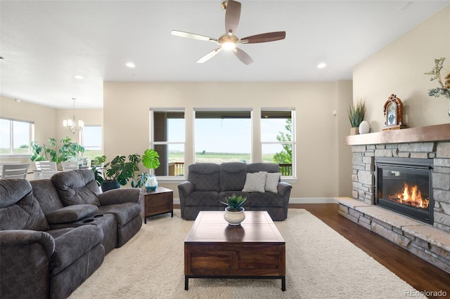 15779 W 83rd Pl, Arvada, CO 80007 - living area featuring a fireplace, a chandelier, a ceiling fan, wood finished floors, and recessed lighting