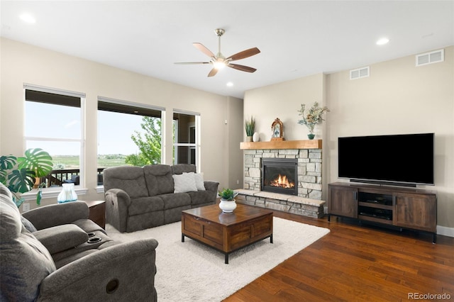 15779 W 83rd Pl, Arvada, CO 80007 - living area with dark wood-style flooring, ceiling fan, recessed lighting, and a stone fireplace