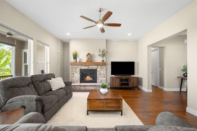 15779 W 83rd Pl, Arvada, CO 80007 - living room featuring ceiling fan, wood finished floors, baseboards, a stone fireplace, and recessed lighting