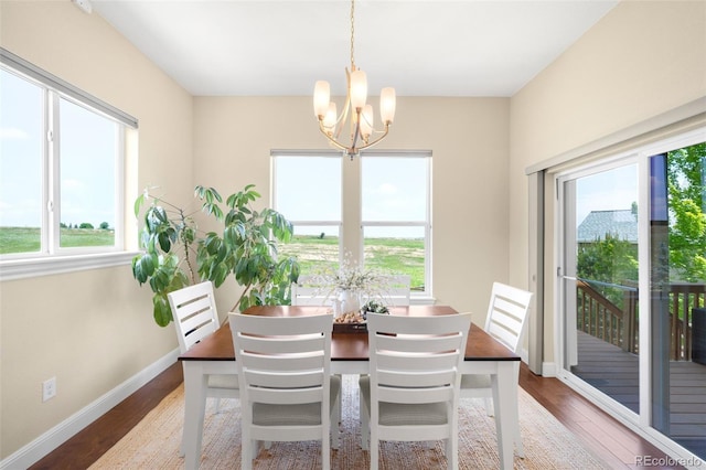 15779 W 83rd Pl, Arvada, CO 80007 - dining space with a chandelier, healthy amount of natural light, and wood finished floors