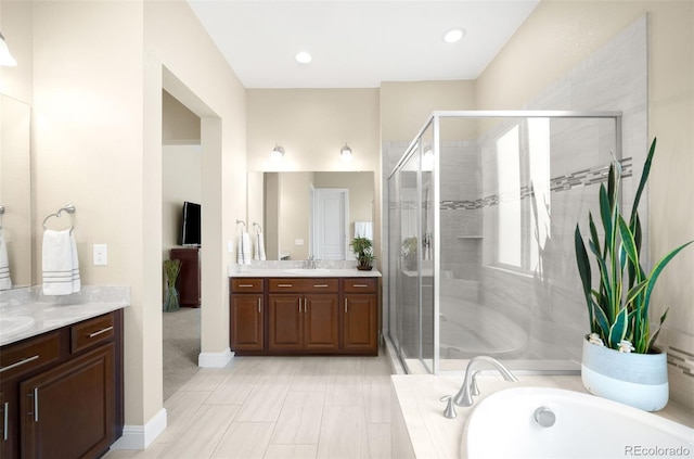 15779 W 83rd Pl, Arvada, CO 80007 - bathroom with vanity, a stall shower, a garden tub, and baseboards