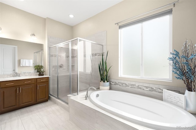 15779 W 83rd Pl, Arvada, CO 80007 - full bath featuring vanity, a garden tub, and a shower stall