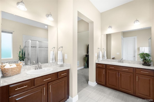 15779 W 83rd Pl, Arvada, CO 80007 - bathroom with two vanities, a stall shower, and baseboards