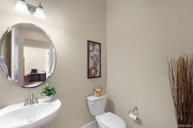 15779 W 83rd Pl, Arvada, CO 80007 - bathroom with a sink, toilet, and baseboards