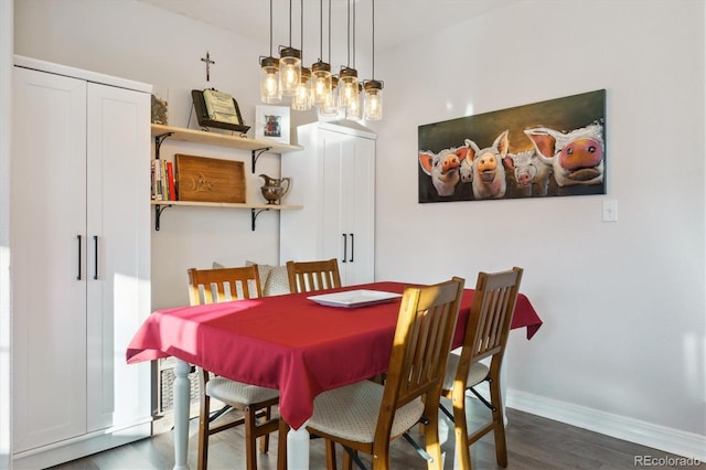 dining room featuring dark wood-type flooring and baseboards