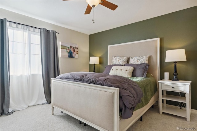 bedroom featuring a ceiling fan and light colored carpet