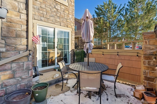 view of patio with outdoor dining area and fence