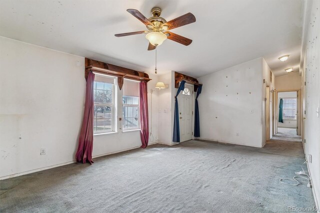 spare room featuring a ceiling fan, carpet, and lofted ceiling