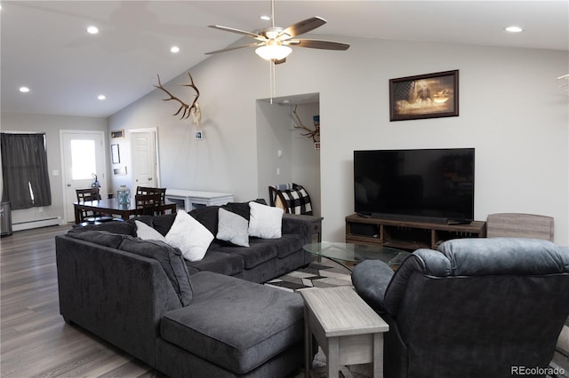 living room with a baseboard heating unit, wood finished floors, a ceiling fan, and lofted ceiling