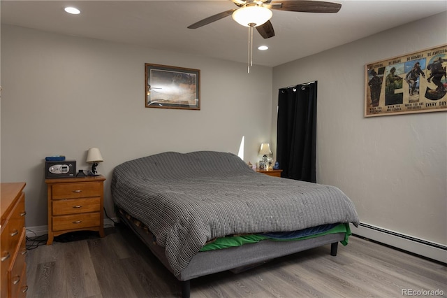 bedroom featuring light wood-style floors, recessed lighting, a baseboard heating unit, and ceiling fan