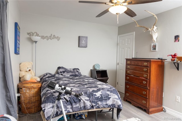 bedroom featuring light wood-type flooring and ceiling fan