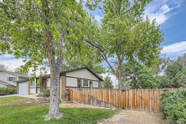 view of front of house with a garage and a front yard