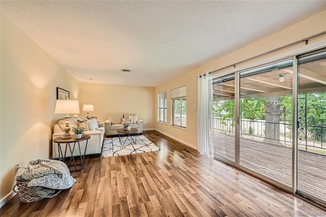 sitting room featuring a textured ceiling and hardwood / wood-style floors