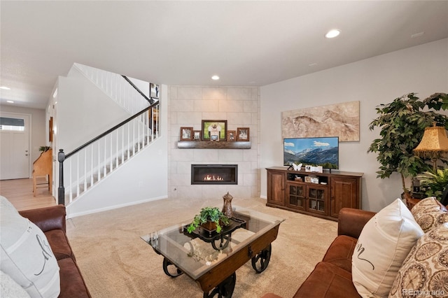 living room with light colored carpet and a tiled fireplace