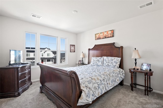 bedroom featuring light colored carpet