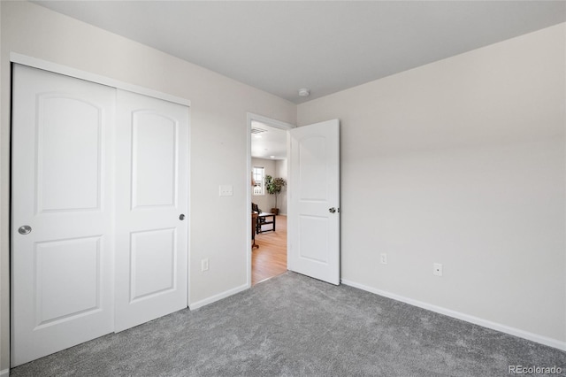 unfurnished bedroom featuring carpet and a closet