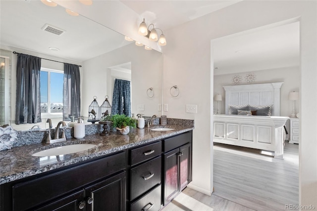 bathroom featuring vanity, hardwood / wood-style floors, and a chandelier