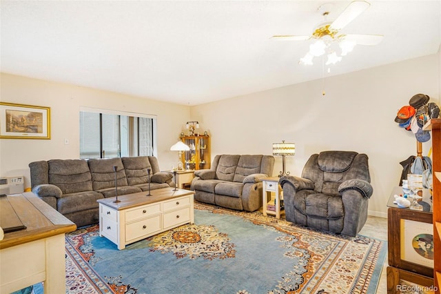 living room with a ceiling fan and baseboards