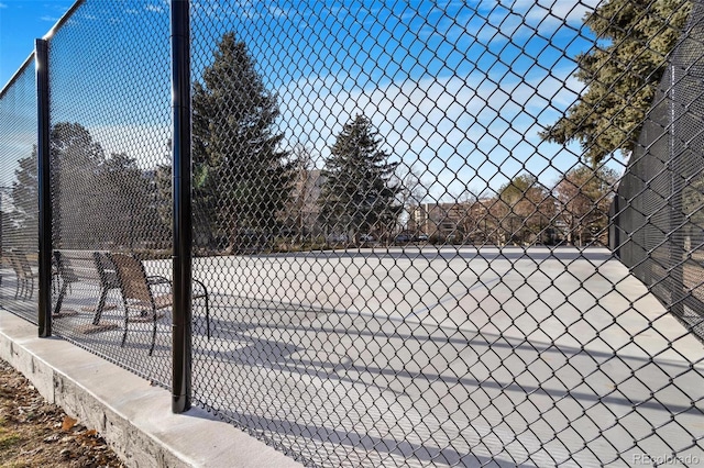 view of tennis court with fence