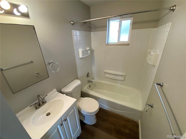 bathroom featuring vanity, wood finished floors, toilet, and washtub / shower combination