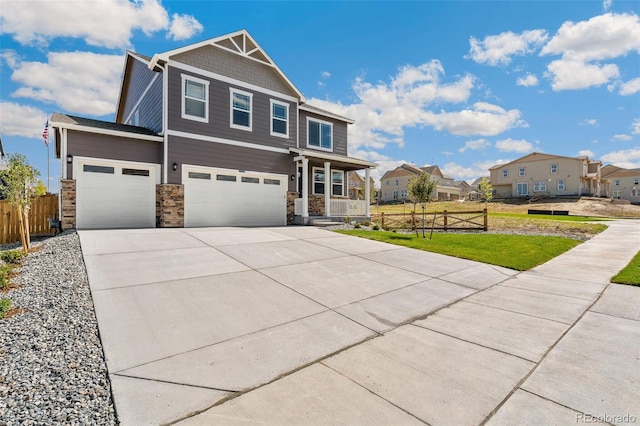 craftsman inspired home with a residential view, covered porch, and fence