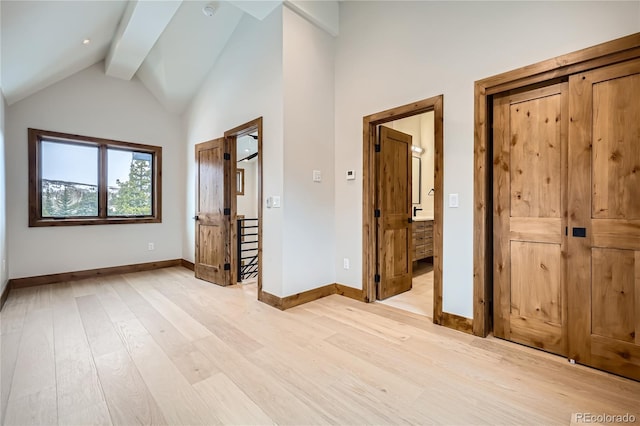 308 Creekside Aly Unit 5, Frisco, CO 80443 - unfurnished bedroom with light wood-type flooring, beam ceiling, and high vaulted ceiling