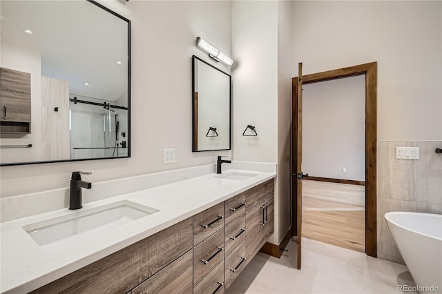 308 Creekside Aly Unit 5, Frisco, CO 80443 - full bathroom with double vanity, a freestanding bath, tile walls, a wainscoted wall, and tile patterned flooring